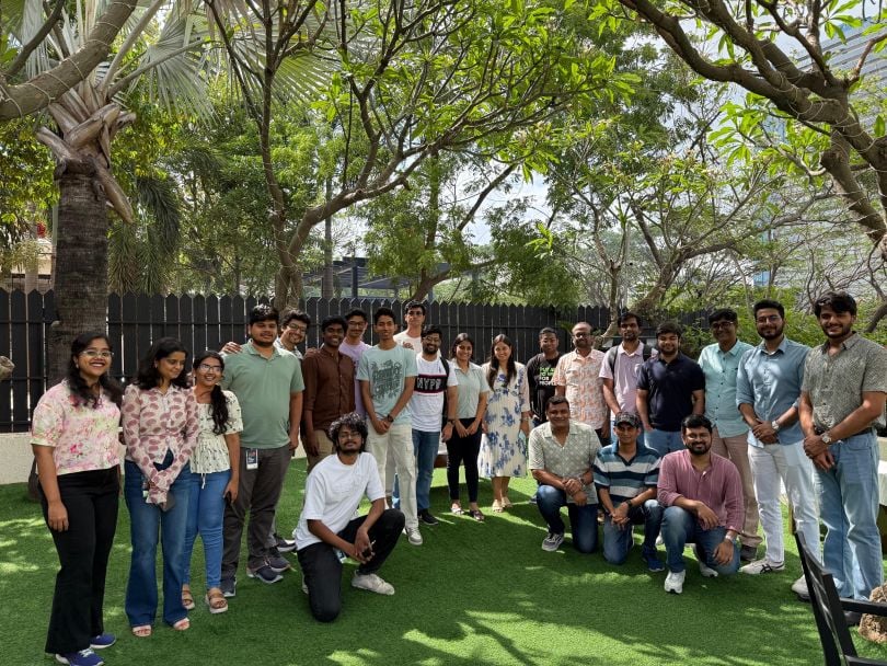 Ranga Prasad Chenna and his teammates pose for a team photo in an outdoor setting